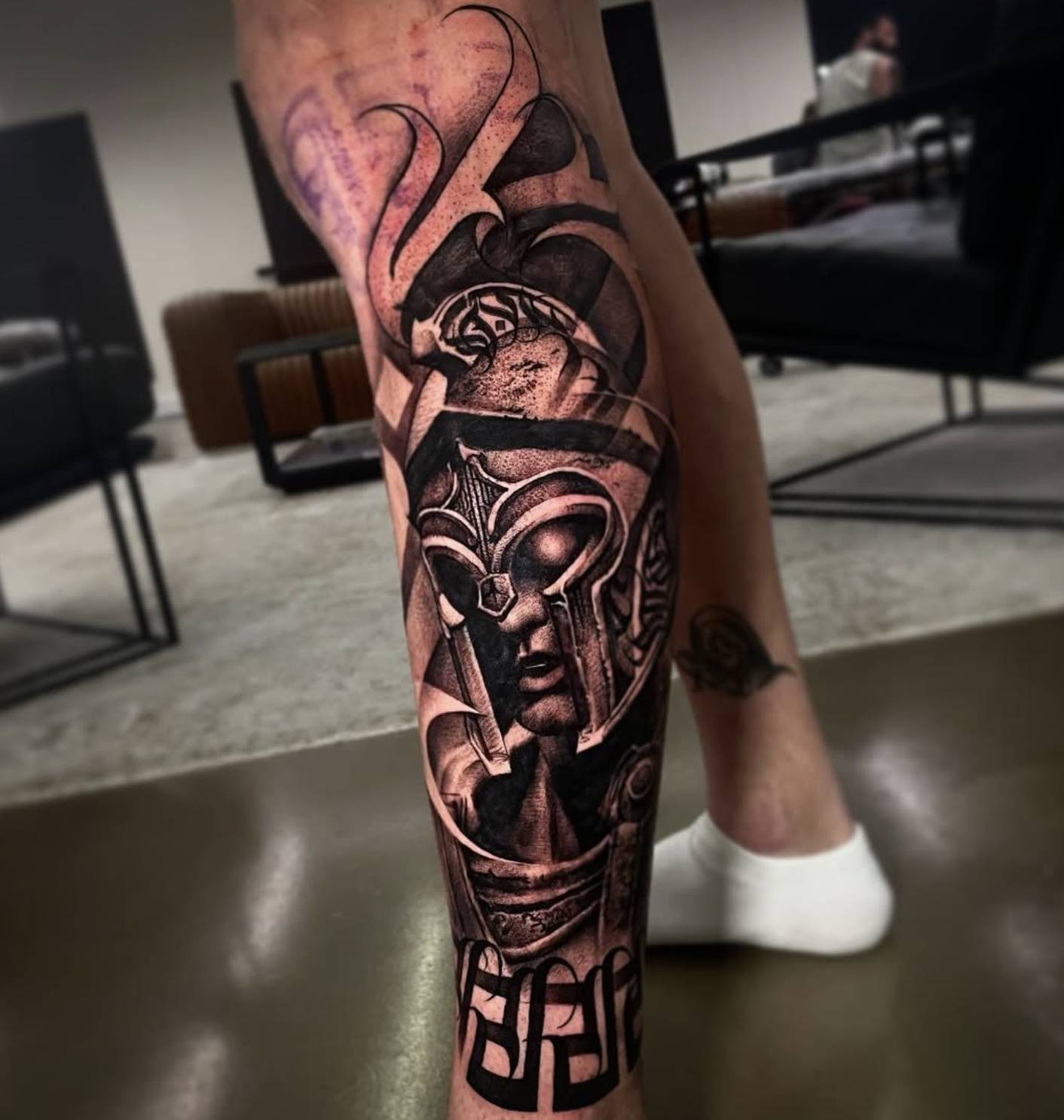 Back of shoulder with large abstract black pattern and linework